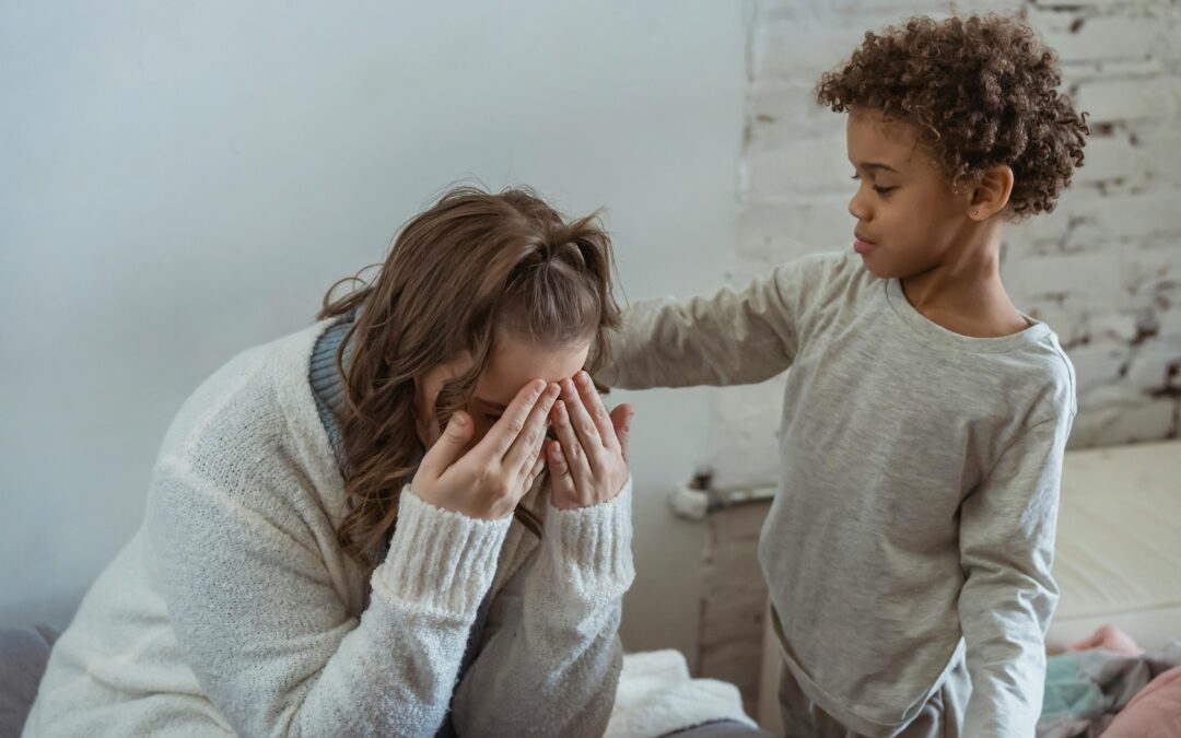 A child trying to comfort a stressed mother.